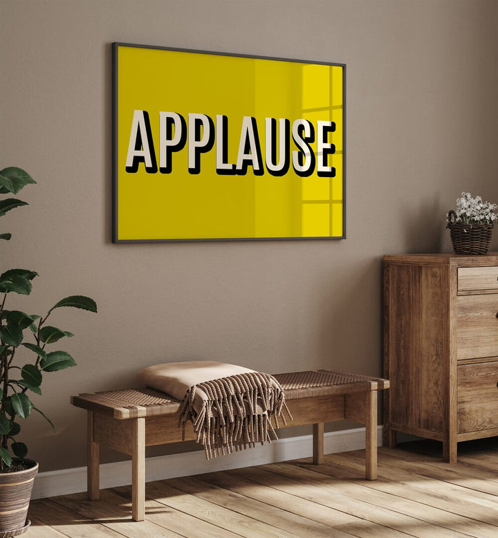 Bright yellow APPLAUSE poster enhances decor, showcasing APPLAUSE, QUOTES for inspiring creativity in any space.