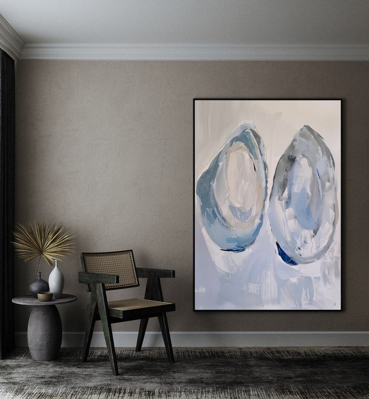 Aquatic Artifacts Beach Prints Coastal Wall Art in Black Plain Frame placed on a wall beside a chair