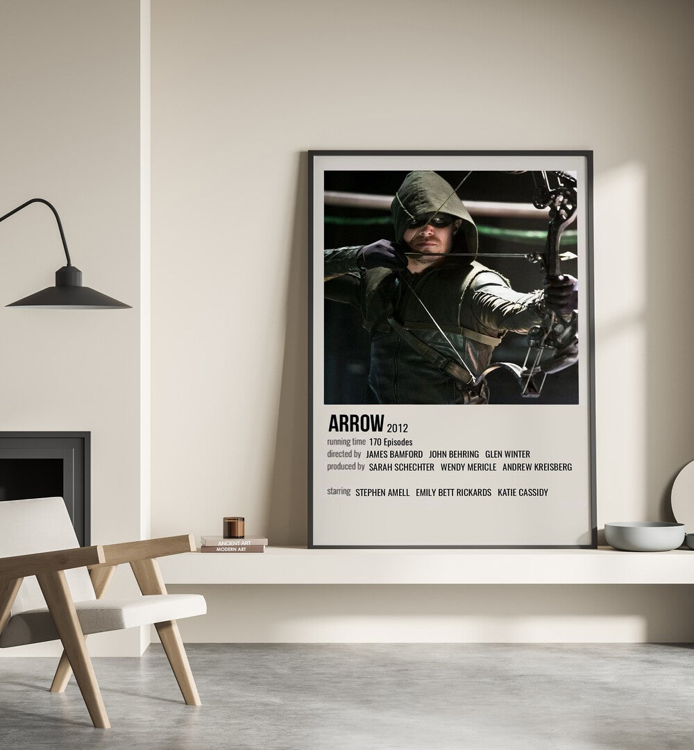 Arrow 2012 Movie Posters in Black Plain Frame place on a wall behind a chair beside lamp