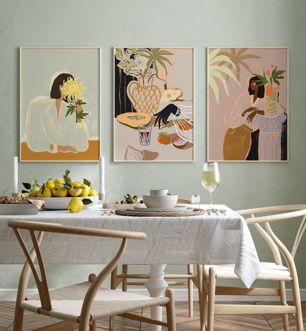 Arty Guava Artworks Set Set Of 3 Paintings in White Plain Frame placed on a green wall behind a dining table  for dining area