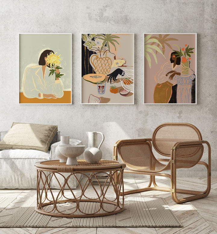 Arty Guava Artworks Set Set Of 3 Paintings in White Plain Frame placed on a wall behind a sofa and a chair