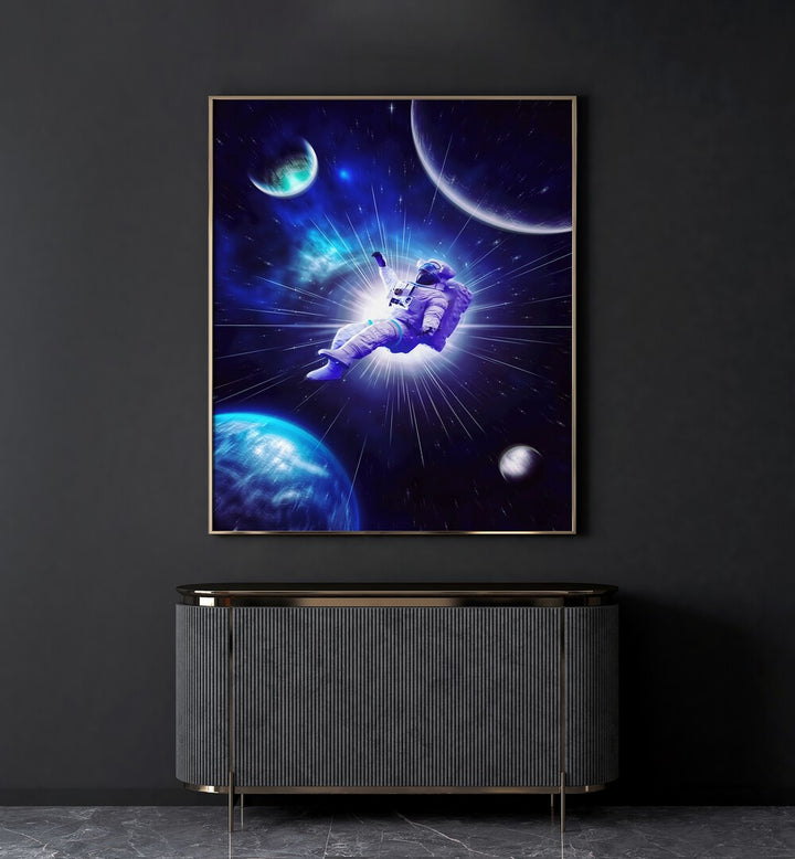 Astro Travel By Ritvik Takkar Surreal Art Prints in Gold Plain Frame placed on a Dark Grey Colored Wall above a Console Table in the Drawing Room