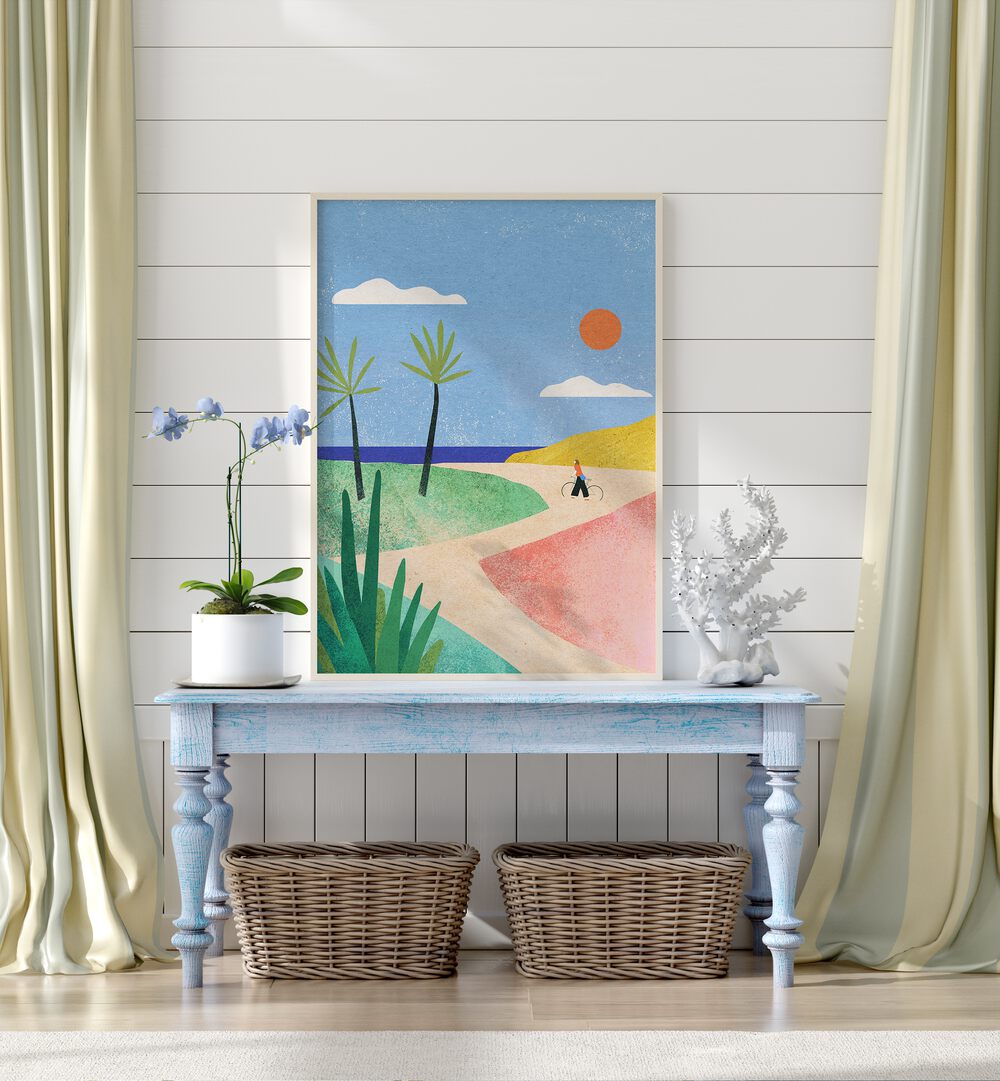 Beach Girl Landscape Art Artwork in Oak Wood Plain Frame place on a Blue Wooden Side Table leaning on a White Stripped Wall