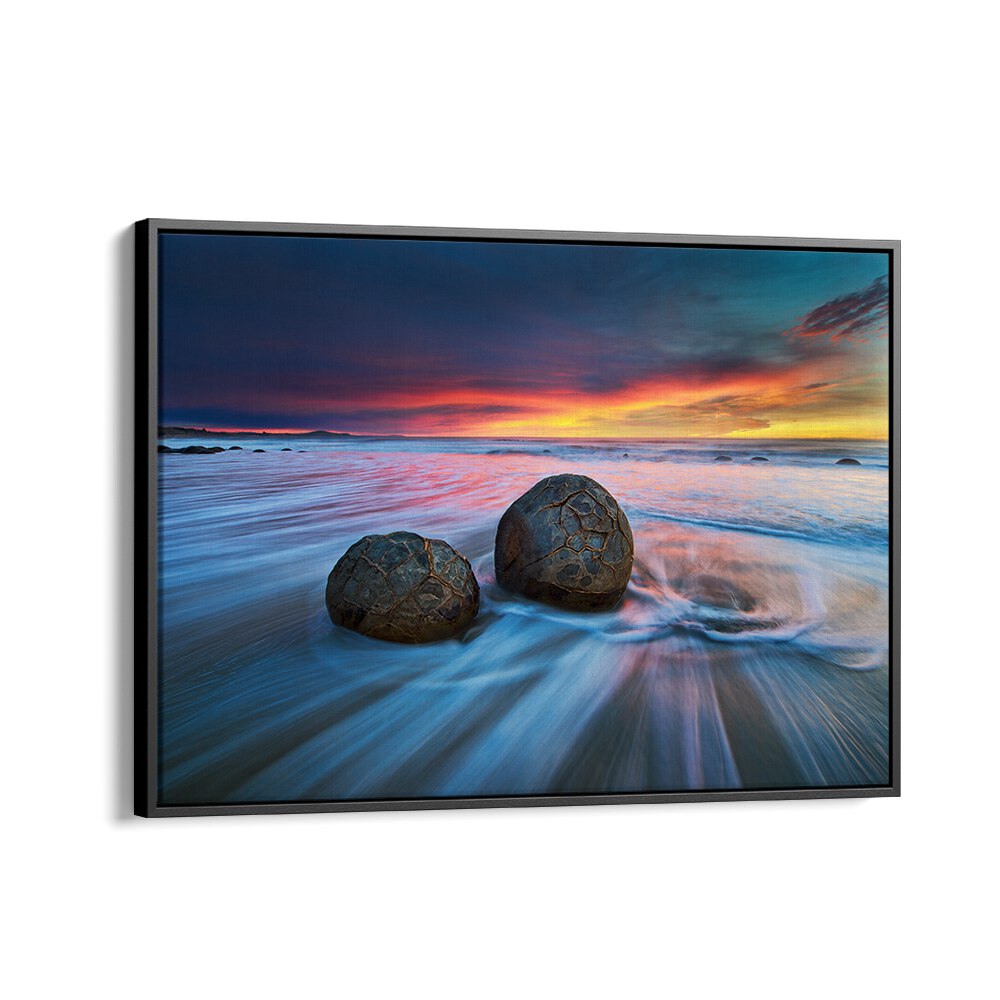 Stunning MOERAKI BOULDERS, PHOTOGRAPHY PRINTS showcasing unique rock formations against a vibrant sunset backdrop.
