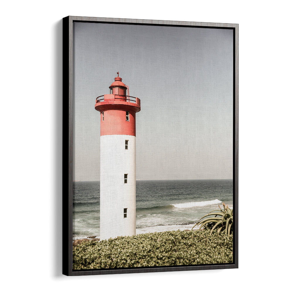 BEACON BY THE SEA , BEACH PAINTINGS framed BlackFloater print of a red-topped lighthouse overlooking the sea and coastal foliage