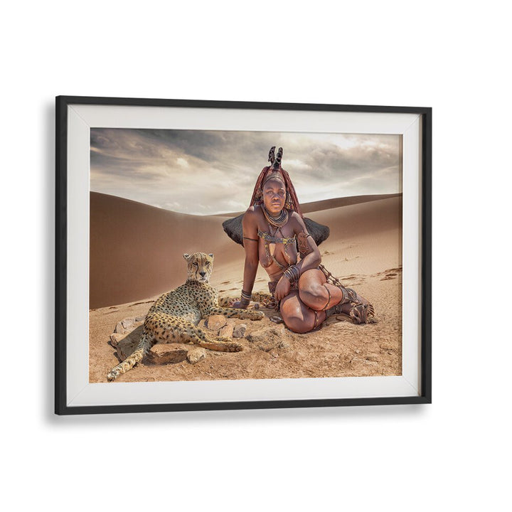 HIMBA FRIENDS, PHOTOGRAPHY PRINTS showcase a stunning scene of a woman and a cheetah in the serene desert landscape.