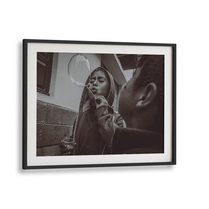 A boy blowing bubbles captures the essence of urban life in CUSCO STREET, PHOTOGRAPHY PRINTS for art lovers.
