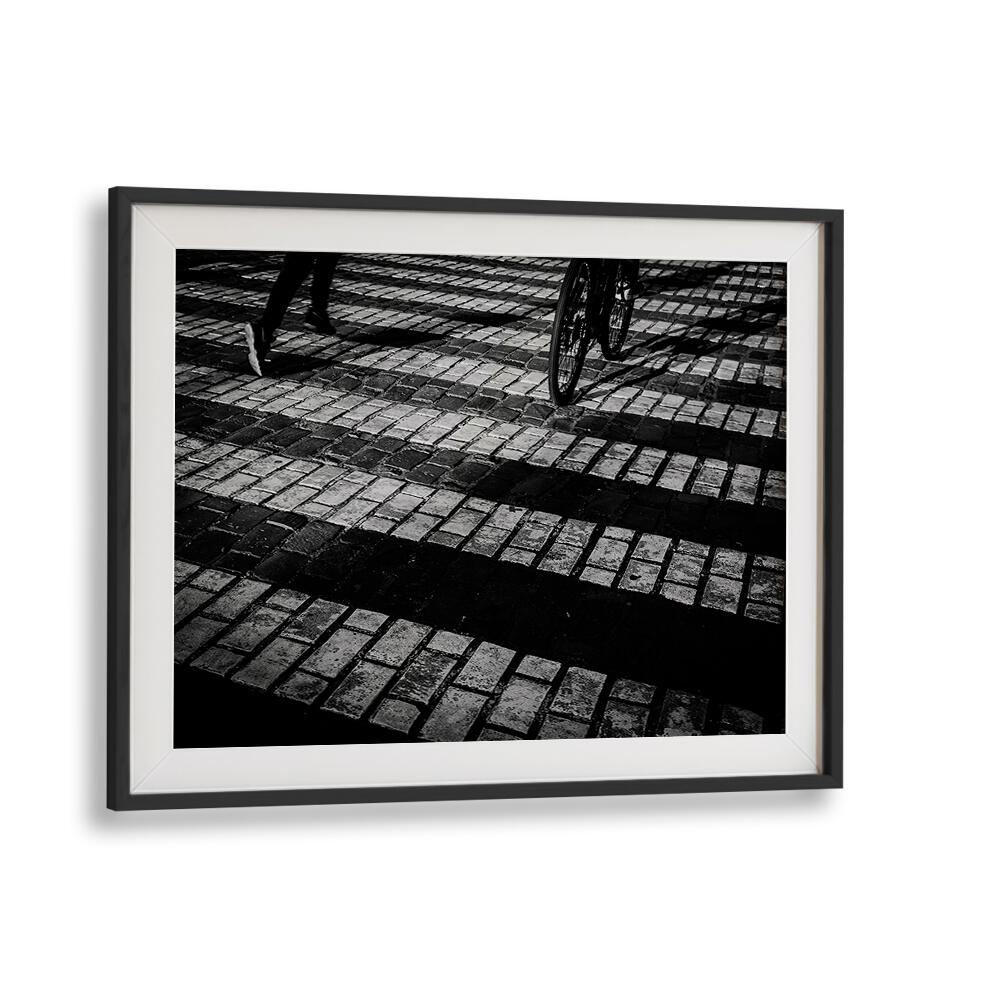 Stylish RUN A BIKE, PHOTOGRAPHY PRINTS showcasing a cyclist on textured cobblestones, blending art and motion.