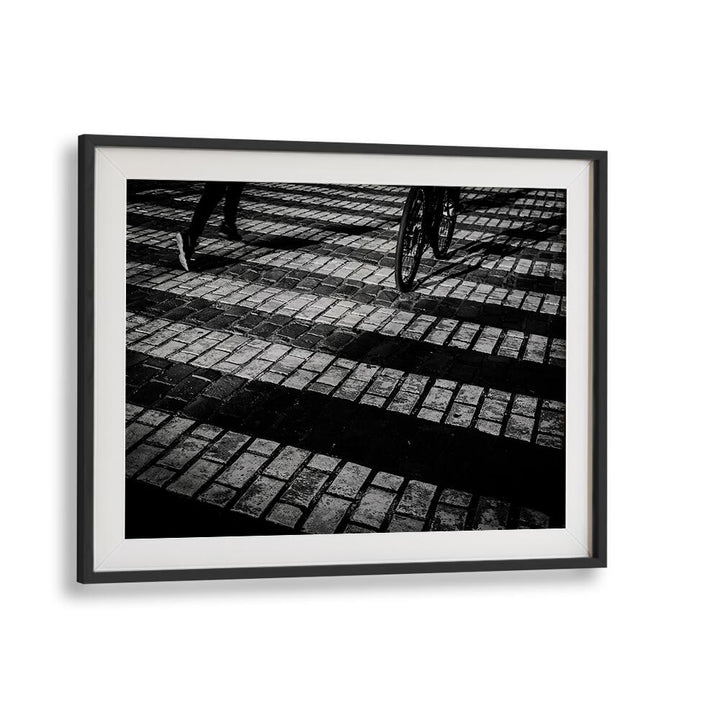 Stylish RUN A BIKE, PHOTOGRAPHY PRINTS showcasing a cyclist on textured cobblestones, blending art and motion.