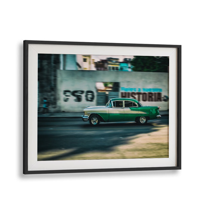 A vibrant vintage car in motion illustrates THE HISTORY OF , PHOTOGRAPHY PRINTS, capturing urban life’s essence.