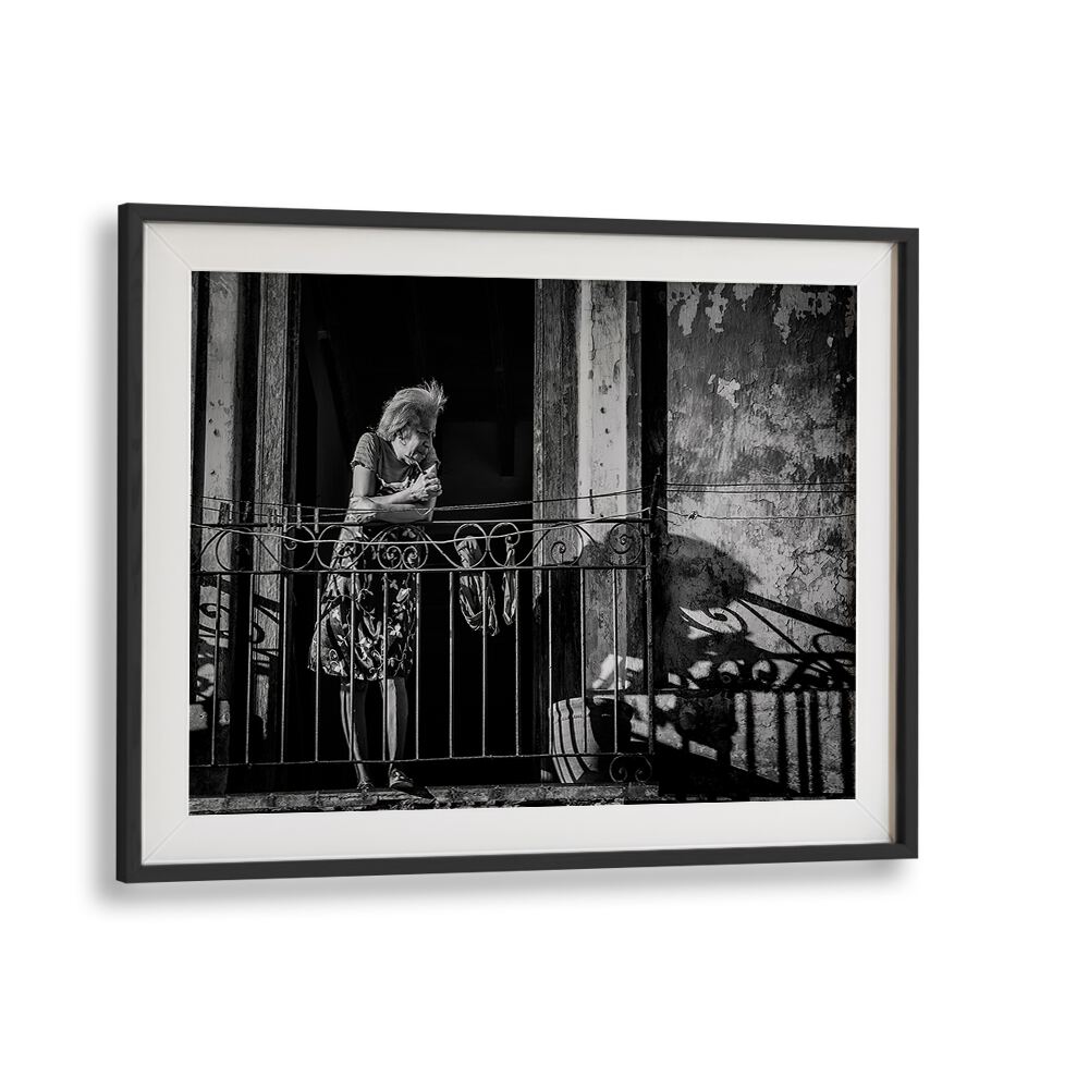 A woman stands on a balcony, embodying daily life in HABANA STREET VI, PHOTOGRAPHY PRINTS collection.