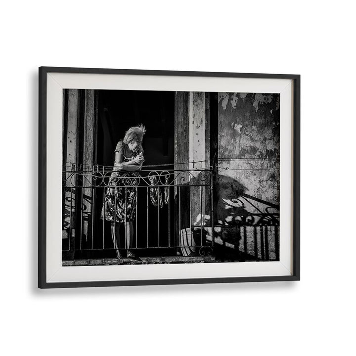A woman stands on a balcony, embodying daily life in HABANA STREET VI, PHOTOGRAPHY PRINTS collection.