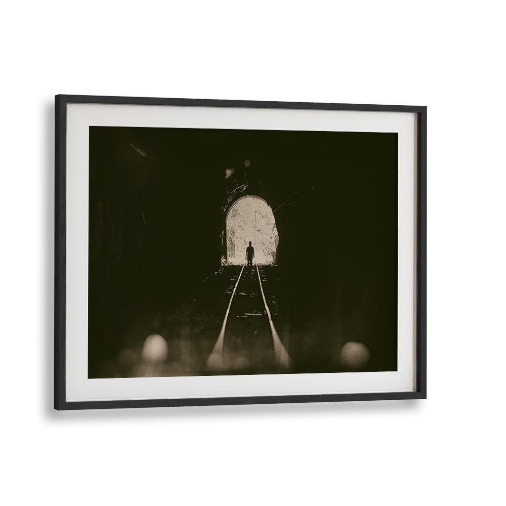 Framed TOWARDS THE LIGHT, PHOTOGRAPHY PRINTS showcasing a figure emerging from a tunnel into bright light.