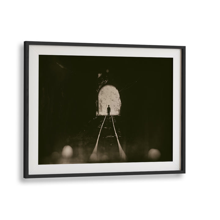 Framed TOWARDS THE LIGHT, PHOTOGRAPHY PRINTS showcasing a figure emerging from a tunnel into bright light.