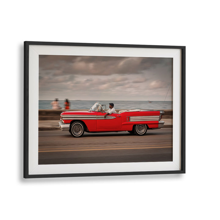 Captivating street scene featuring a red convertible, part of MALECON IX, PHOTOGRAPHY PRINTS collection.
