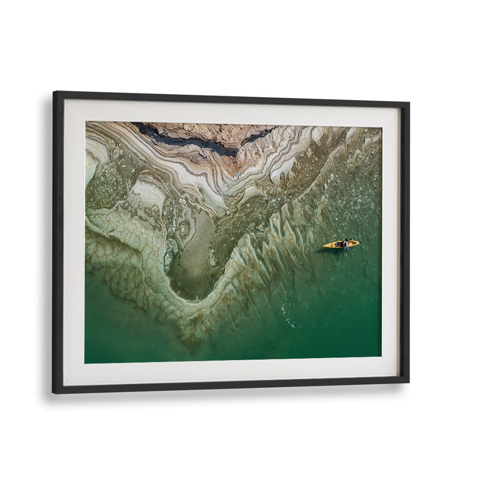 Kayaker glides over the serene waters of the Dead Sea, featured in our DEAD SEA KAYAKER, PHOTOGRAPHY PRINTS.