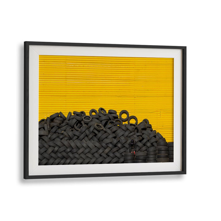 Fine art TIRES, PHOTOGRAPHY PRINTS showcasing a striking black tire pile against a vibrant yellow backdrop.