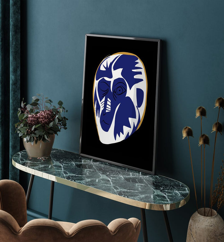 Blue Baboon Abstract Art Painting Artwork in plain black frame on a table beside a flower pot