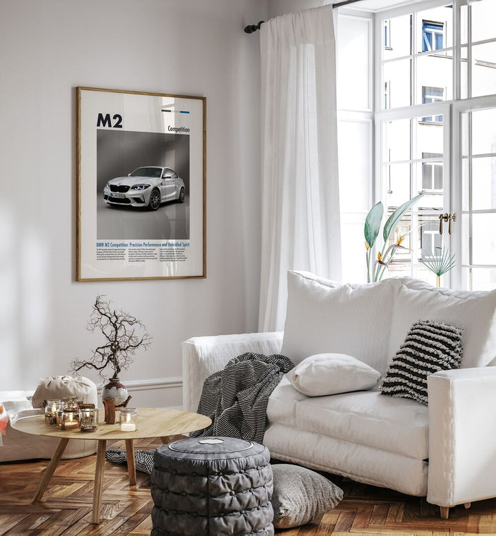 BMW M2 Competition Car Posters Automotive Wall Art Prints in Oak Wood Plain Frame placed on a White Colored Wall near a White Sofa in the Living Room