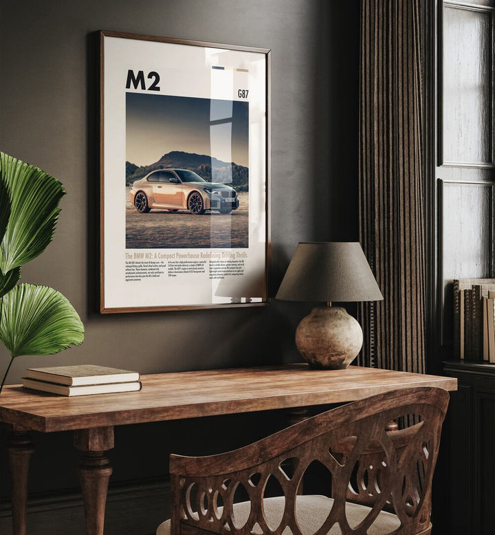 BMW M2 G87 Car Posters Automotive Wall Art Prints in Dark Wood Plain Frame placed on a Dark Brown Colored Wall Above a Study Table in a Workspace in the Drawing Room