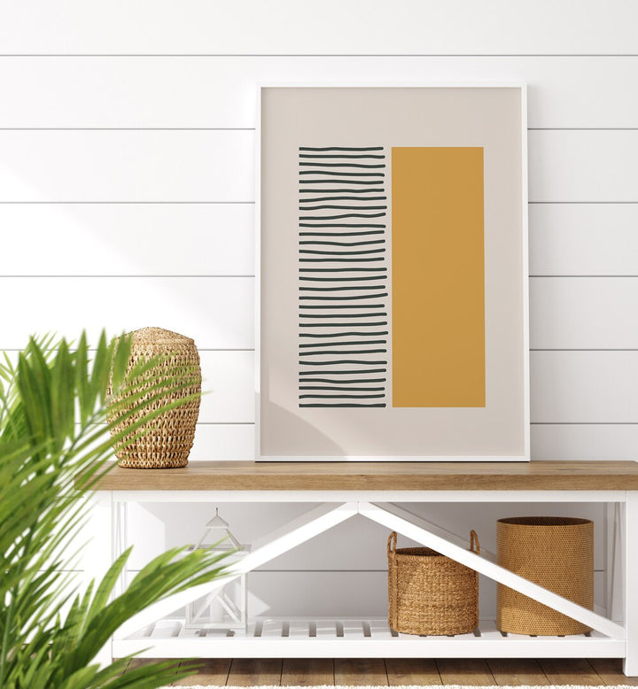 Bold Yellow And Black Stripes Geometric Art Painting Artwork in plain white frame on a table behind a plant