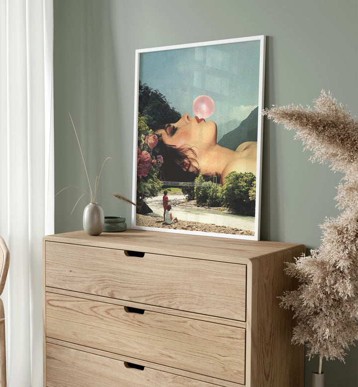 Bubble Gum Girl Surreal Art Painting Artwork in plain white frame above a console table beside an artificial plant