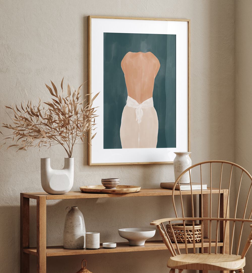 Back Side By Ivy Green Women Illustration Paintings in Oak Wood Frame With Mount on a beige wall above a table