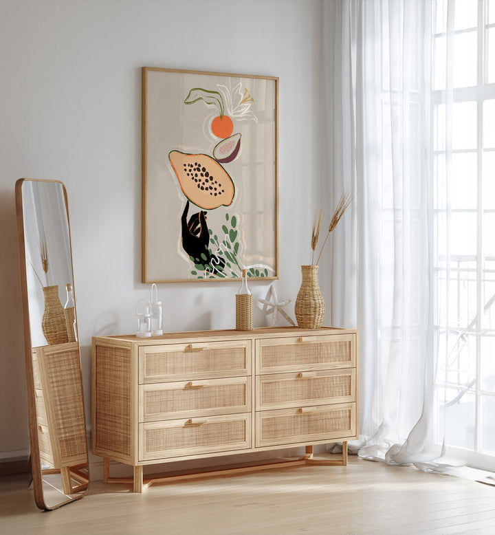 Balancing Fruits By Arty Guava Wall Art Prints in Oak Wood Plain Frame placed on a White Colored Wall above a Console Table in the Drawing Room 