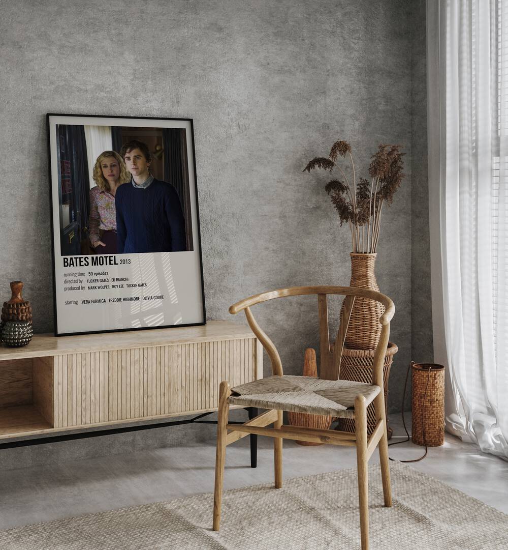 Bates Motel  2013 Movie Posters in Black Plain Frame placed on a table beside oakwood chair