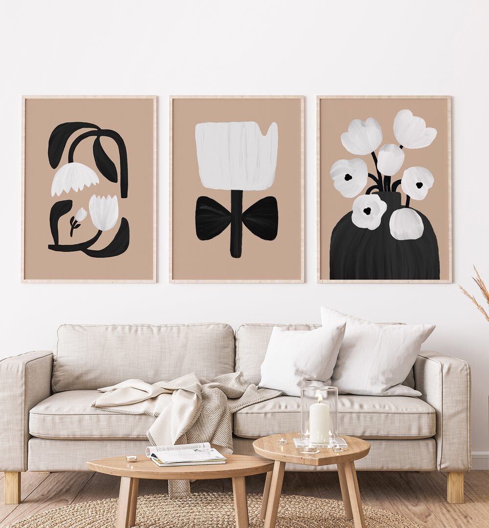 Beige Flowers Set Of 3 Paintings in White Plain Frame placed on a wall living room wall behind a sofa