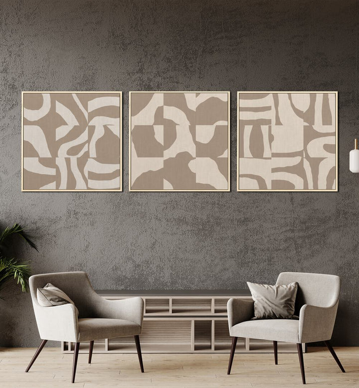 Beige Monochromes Set Set Of 3 Paintings in Oak Wood Plain Frame placed on a wall behind a table and beside a plant