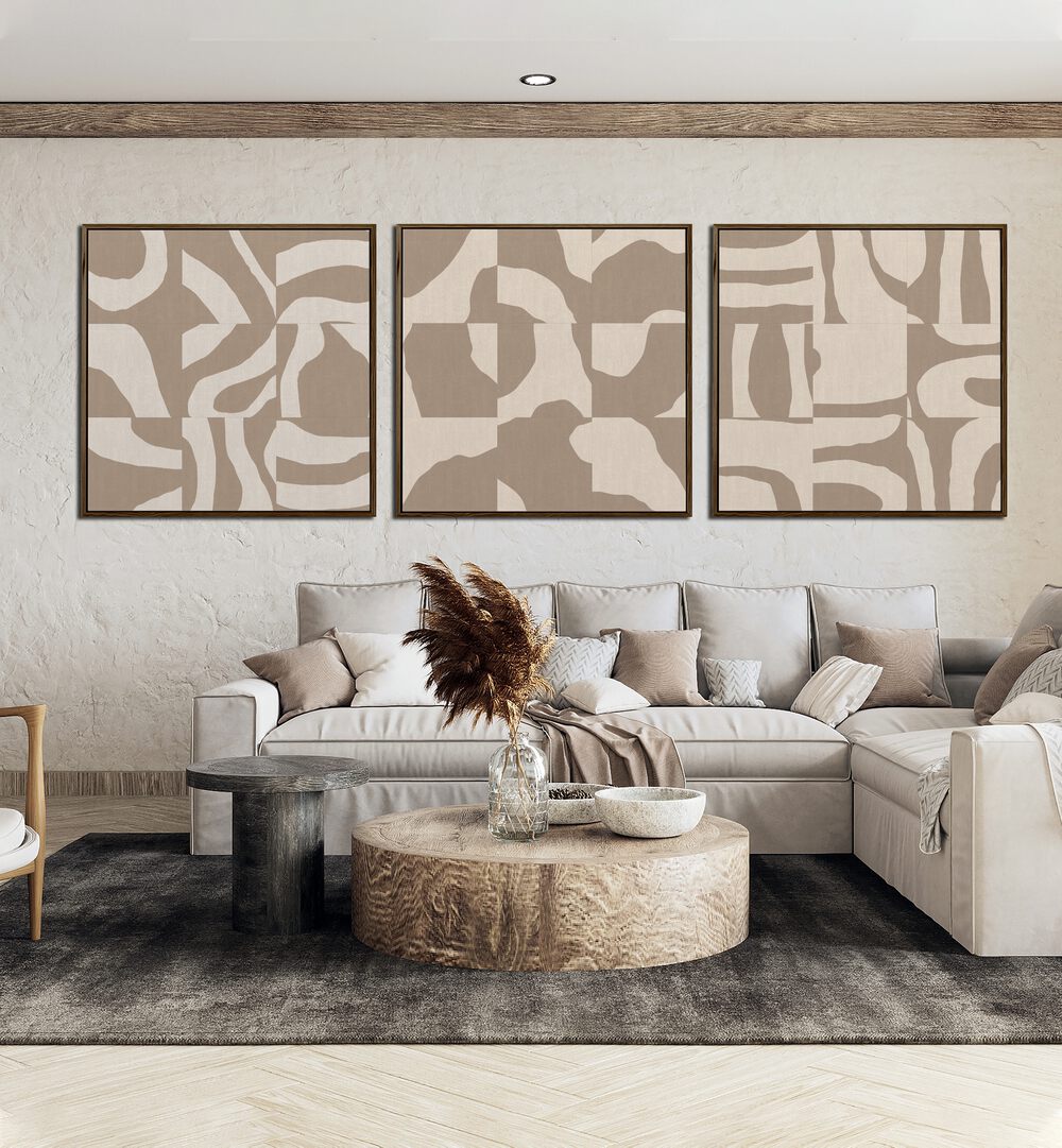 Beige Monochromes Set Set Of 3 Paintings in Black Plain Frame placed on a wall behind a sofa for living room