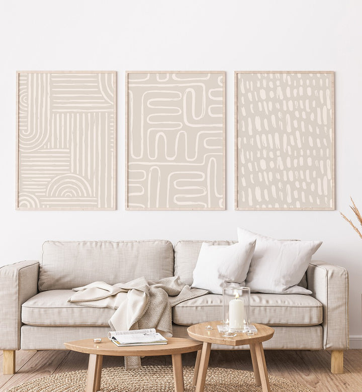 Beige Patterns Set Of 3 Paintings in Oak Wood Plain Frame placed on a living room wall behind a sofa