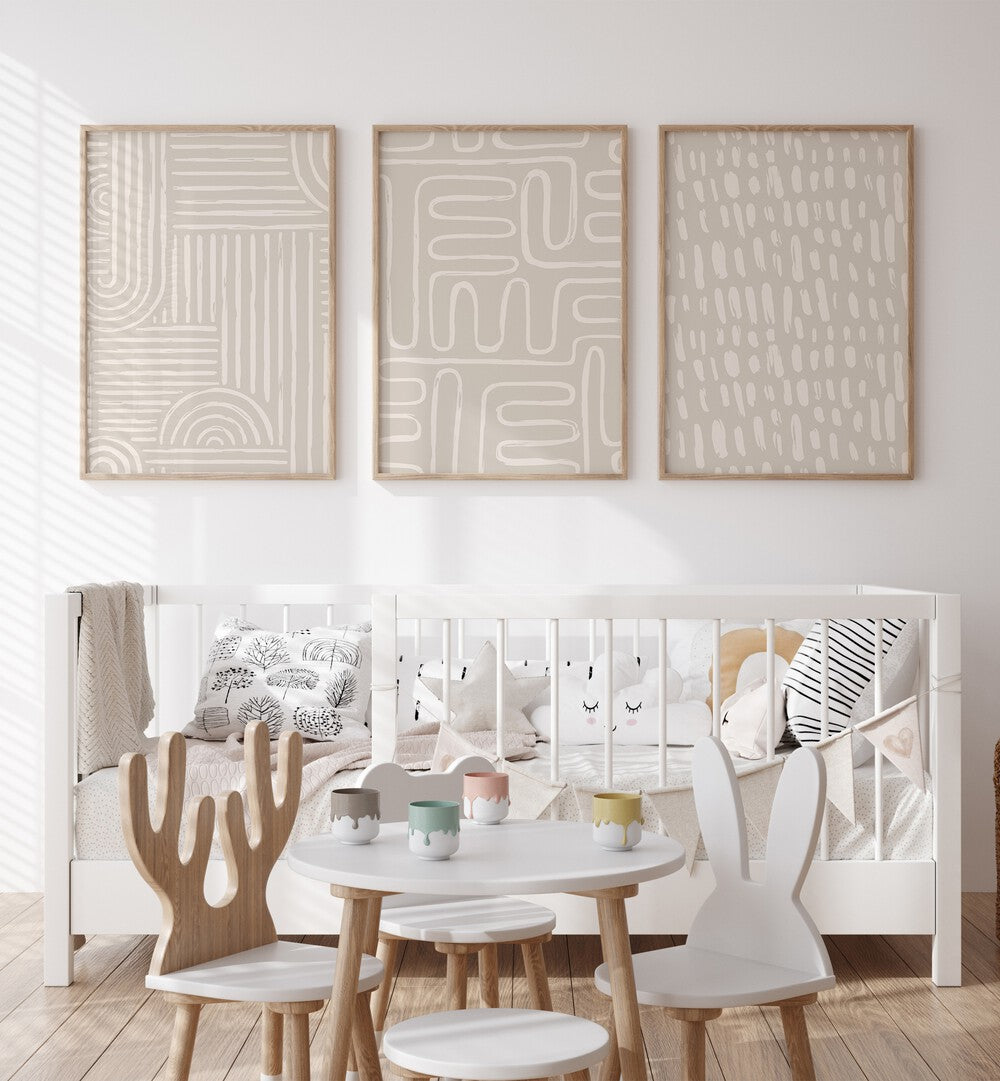 Beige Patterns Set Of 3 Paintings in Oak Wood Plain Frame placed on a kids room wall behind an infant's bed