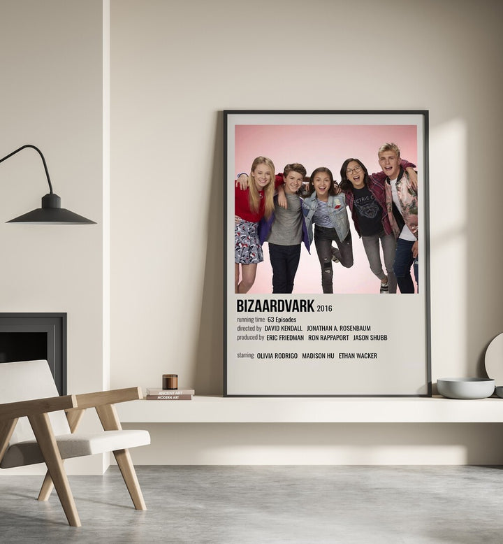 Bizaardvark 2016 Movie Posters in Black Plain Frame place on a wall behind a chair beside lamp