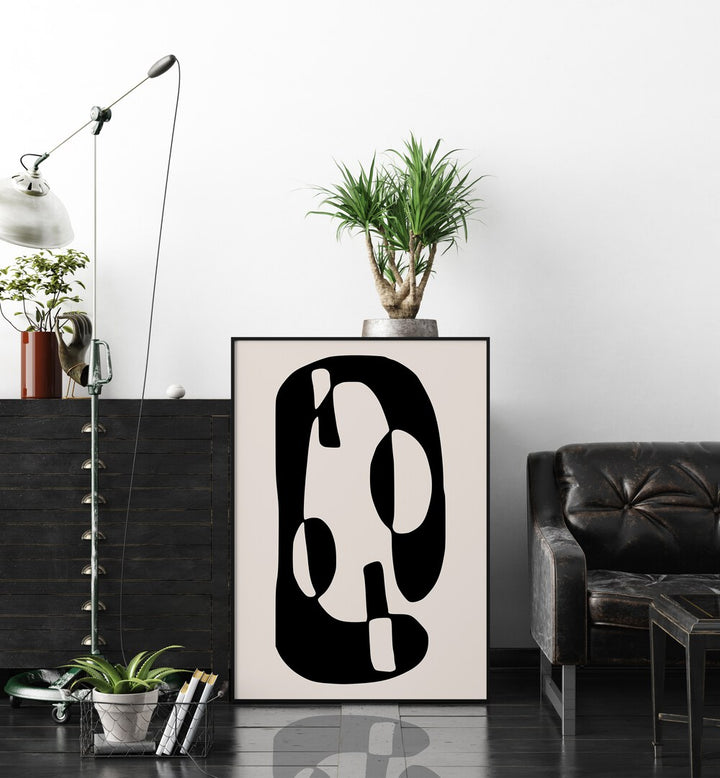 Black And Beige I By Preayna Abstract Art Paintings in Black Plain Frame beside a sofa