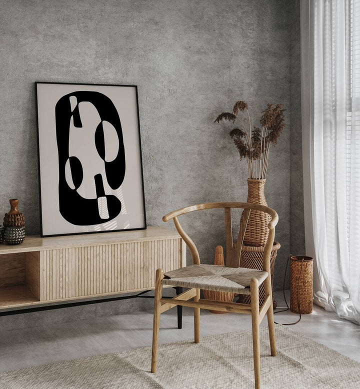 Black And Beige I By Preayna Abstract Art Paintings in Black Plain Frame on a console table beside a showpiece