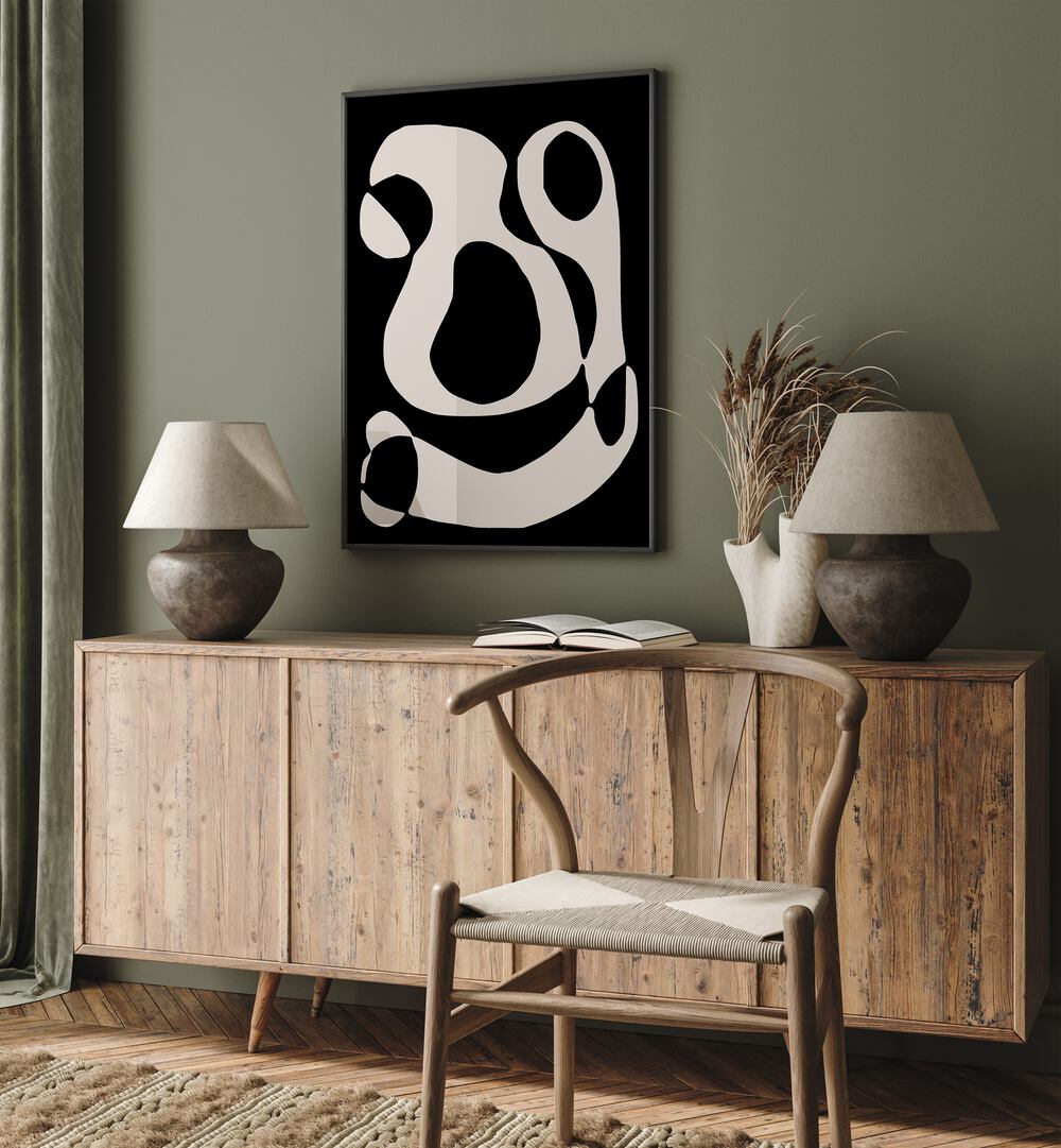 Black And Beige II By Preayna Abstract Art Paintings in Black Plain Frame above a console table beside lamps