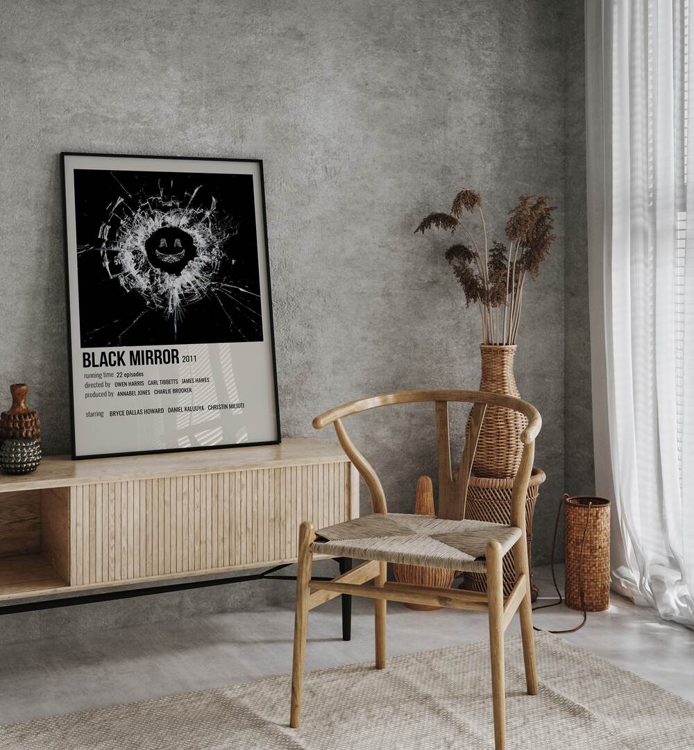 Black Mirror 2011 i Movie Posters in Black Plain Frame placed on a table beside oakwood chair