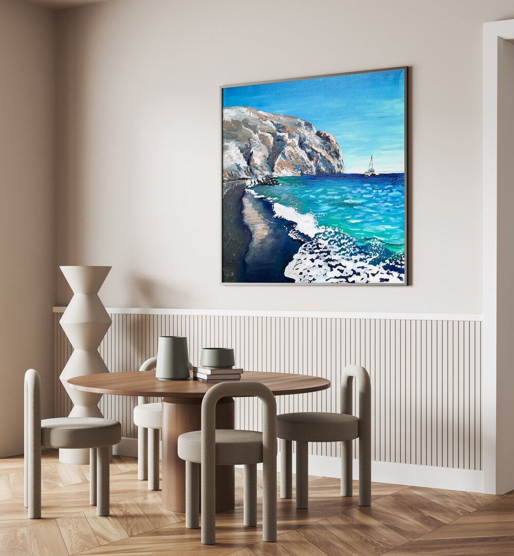 Black Sand Beach By Key And Sea Creative Landscape Artwork in Black Plain Frame on a cream wall behind a dining table