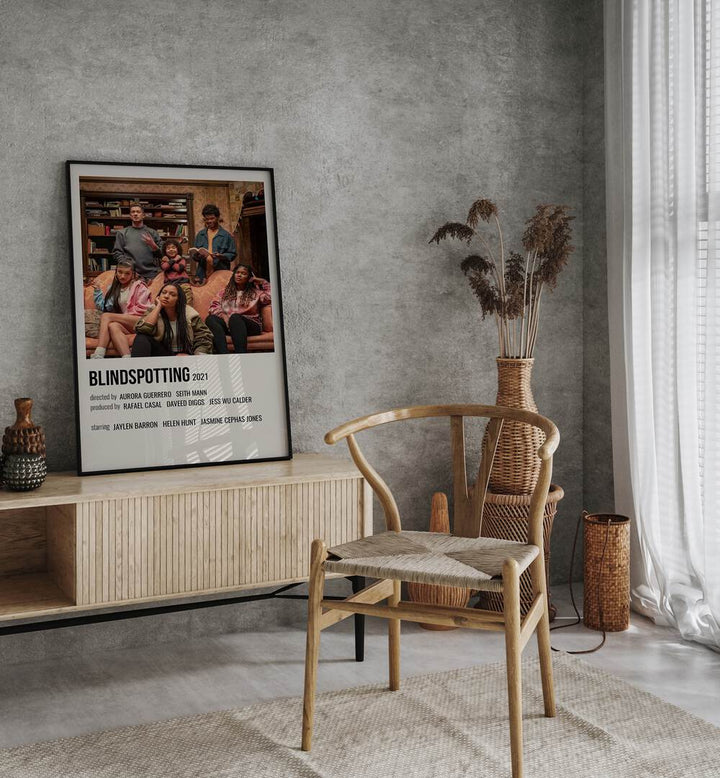 Blindspotting 2021 Movie Posters in Black Plain Frame placed on a table beside oakwood chair