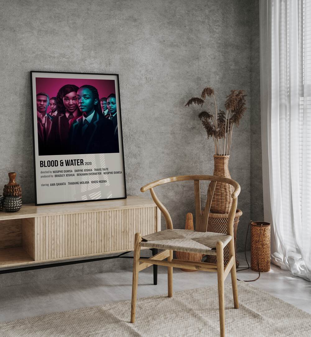 Blood Water 2020 Movie Posters in Black Plain Frame placed on a table beside oakwood chair