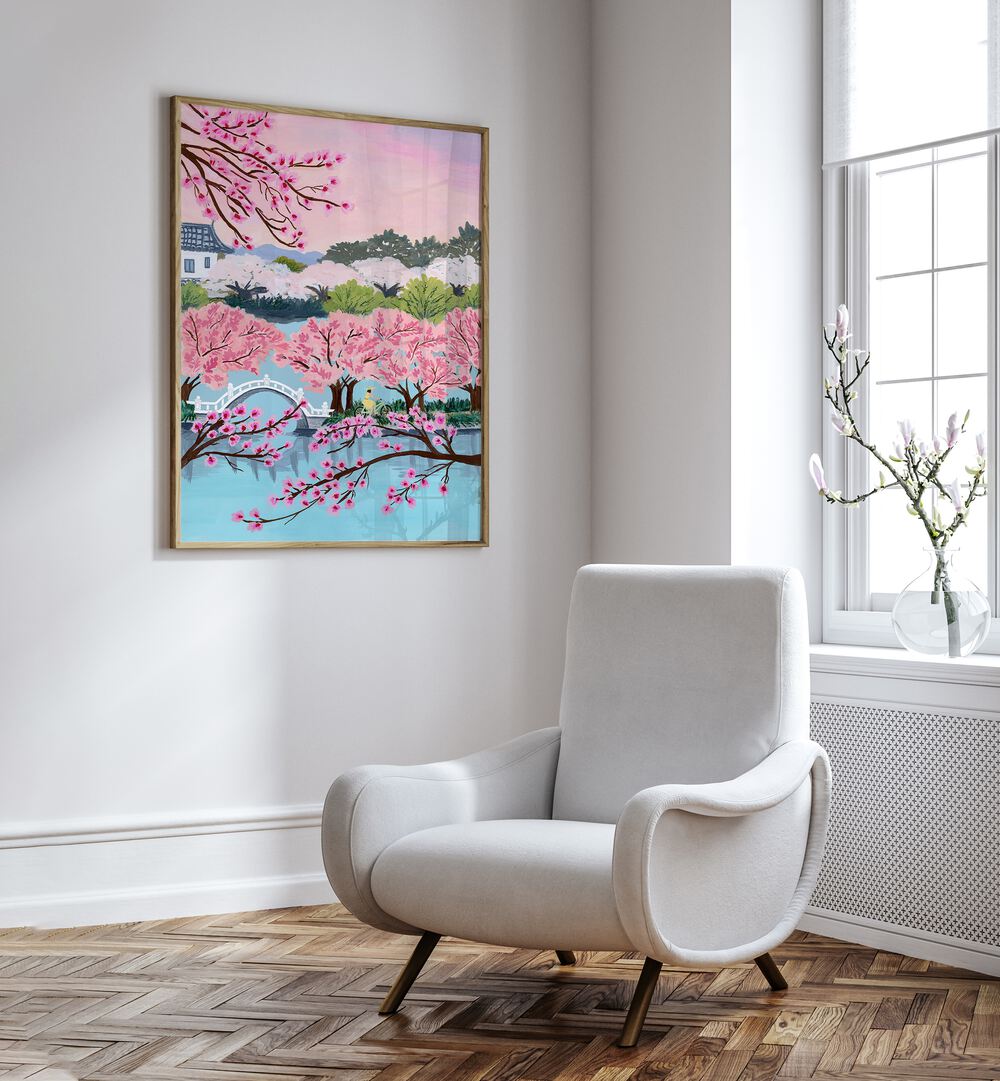 Blossom Ride By Sarah Gesek Landscape Art Prints Floral Paintings in Oak Wood Plain Frame placed on a white wall beside a chair and a window