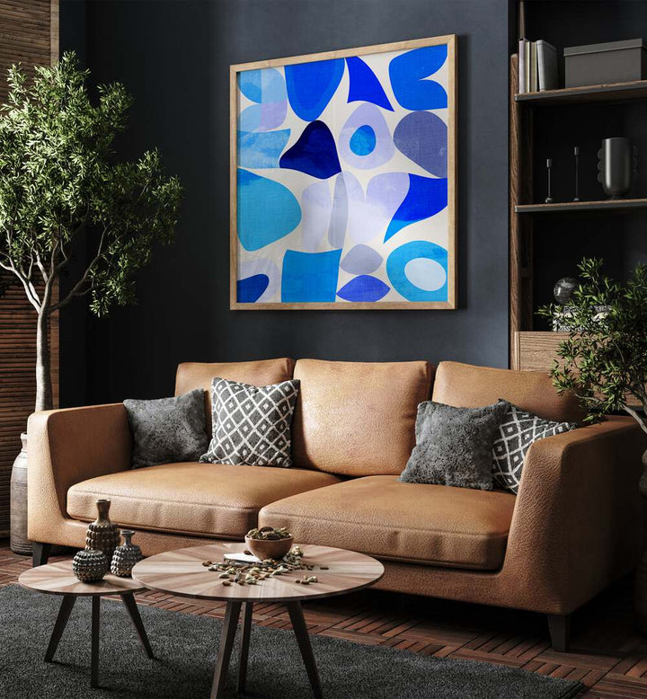 Blue Abstract Kopie I By Ana Rut Bre Abstract Art Abstract Paintings in Oak Wood Plain Frame placed on a Dark Grey Colored Wall near a Brown Sofa in the Living Room