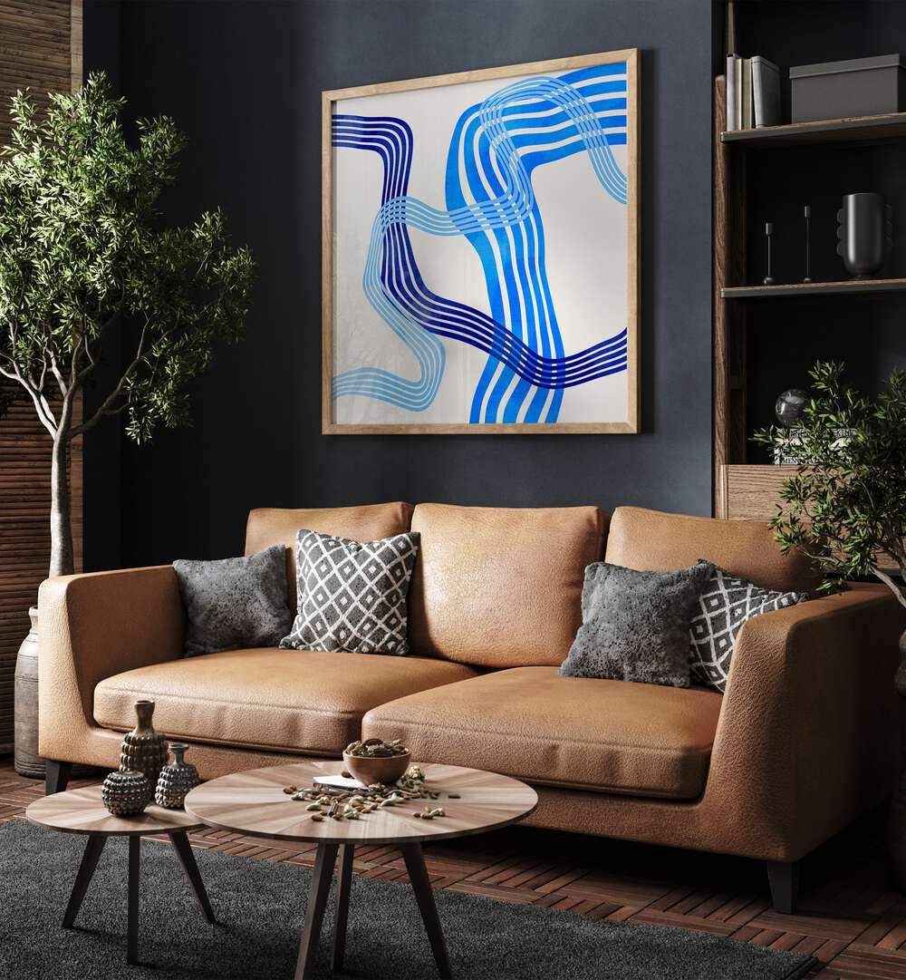 Blue Abstract Kopie IV By Ana Rut Bre Abstract Art Abstract Paintings in Oak Wood Plain Frame placed on a Dark Grey Colored Wall near a Brown Sofa in the Living Room