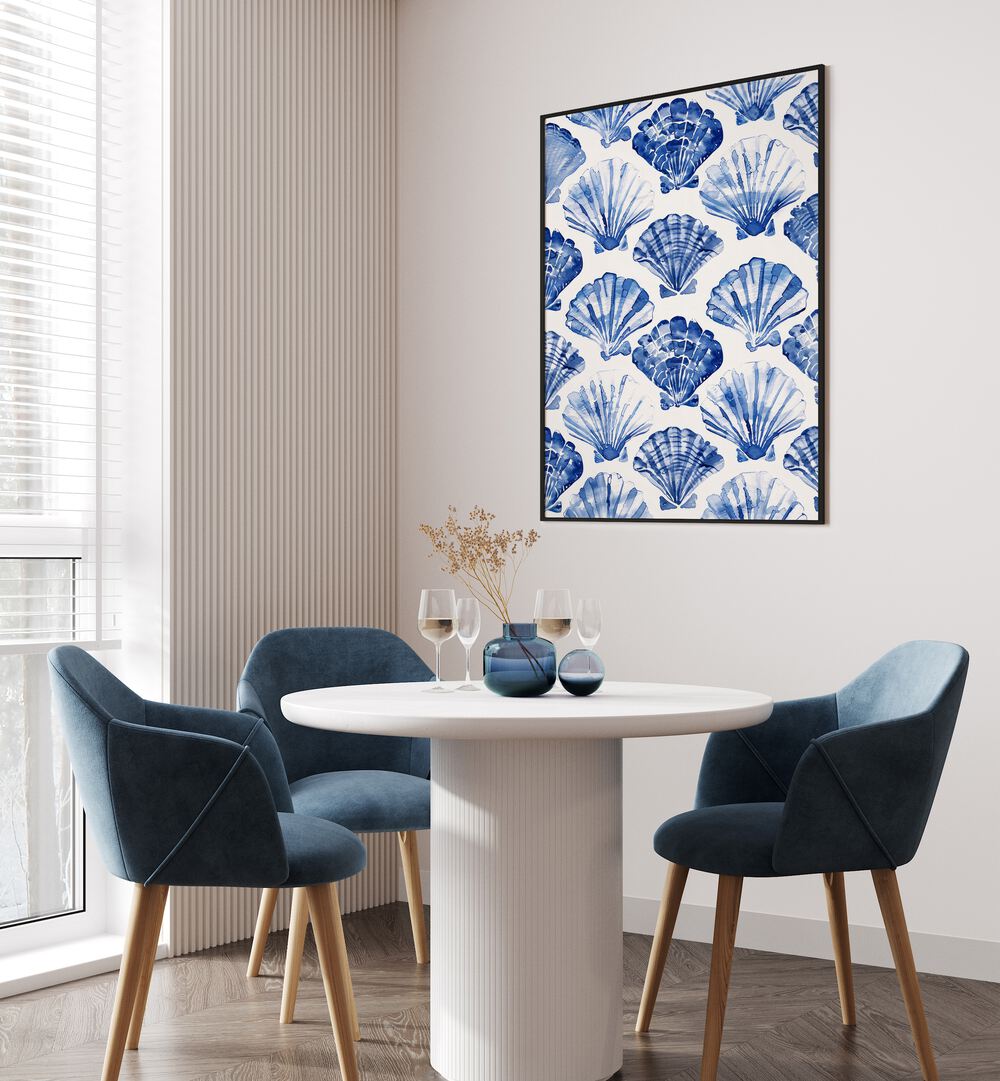 Blue Ocean Bivalve Beach Prints Coastal Wall Art in Black Plain Frame placed on a white wall behind a dining table