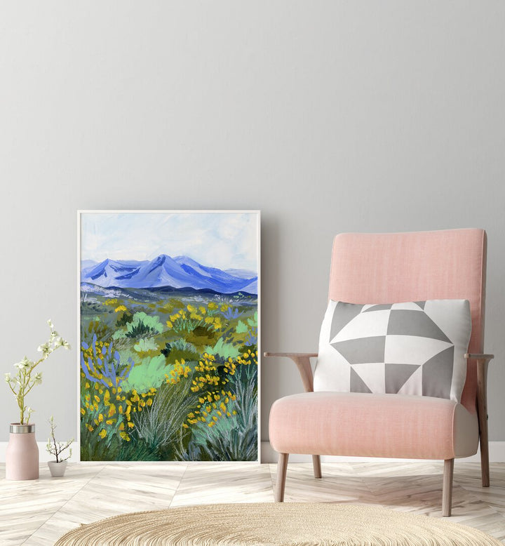 Blue Valley By Sarah Gesek Landscape Art Prints in White Plain Frame placed on the floor beside a sofa