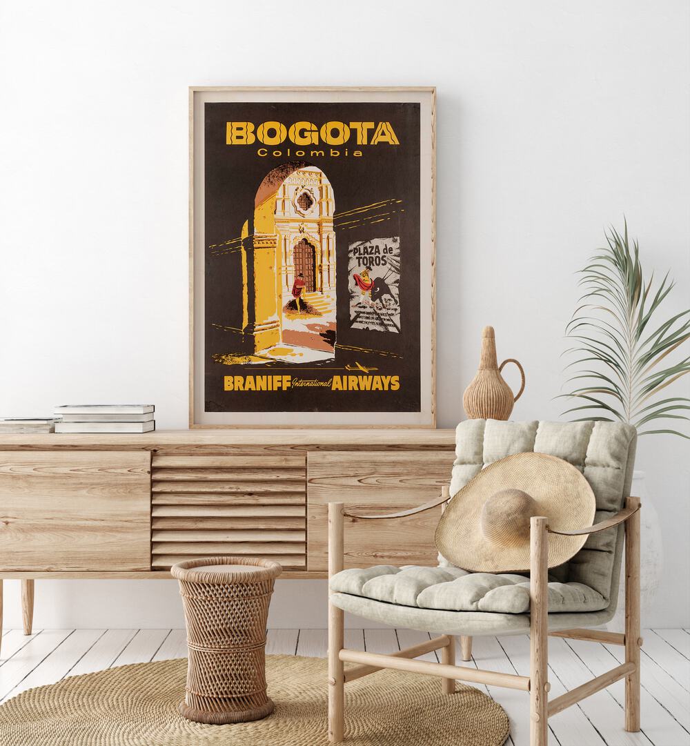 Bogota-Columbia  Retro Travel Posters in Oak Wood Plain Frame placed on a console table behind a chair