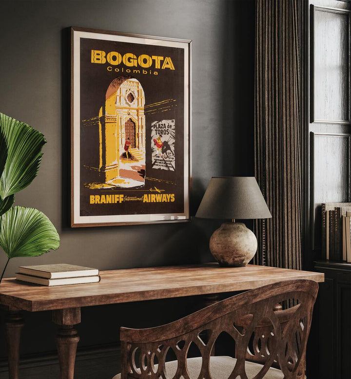 Bogota-Columbia  Retro Travel Posters in Dark Wood Plain Frame placed on a wall behind a study table