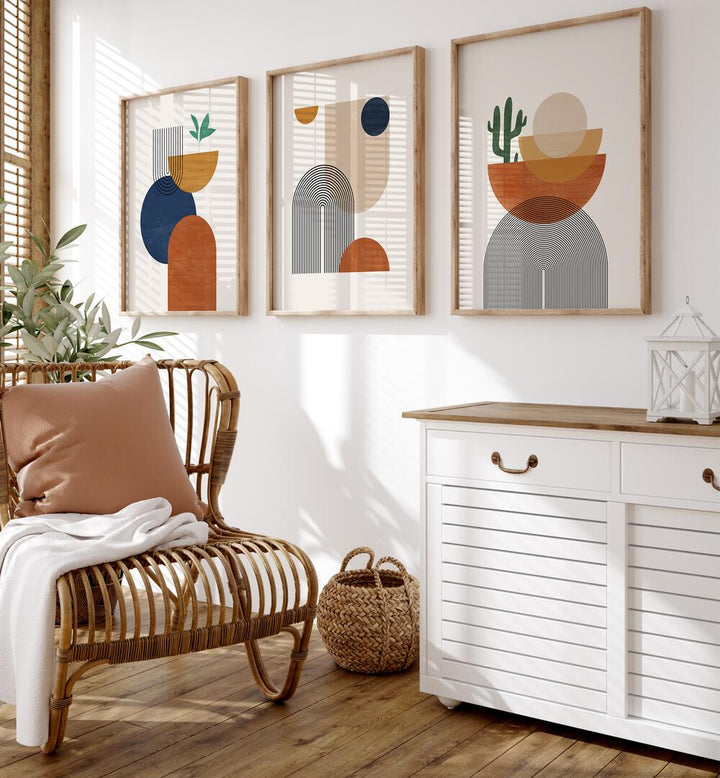 Boho Dessert Geometry Set Of 3 Paintings in Oak Wood Plain Frame placed on a wall beside a chair and a console table